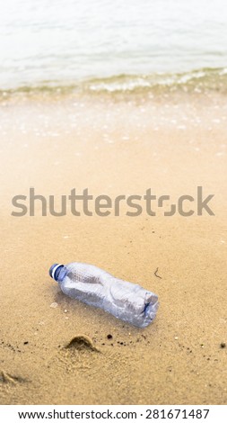 An empty plastic mineral water bottle on clean and empty beach