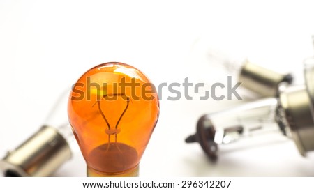 Car halogen bulb or headlight lamp. Concept of safety light and bright technology idea. Isolated on white background. Slightly de-focused and close-up shot. Copy space.