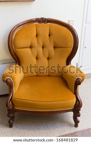 Antique orange armchair isolated on white background
