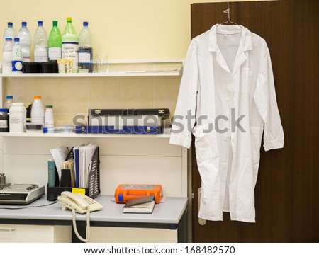 white robe hanging on a door in laboratory