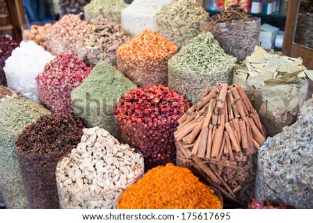 A spice vendor\'s display at a local market in Dubai: colorful, powdered spices in large sacks