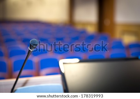 Rostrum with microphone and computer in conference hall Rostrum with microphone and computer in conference hall