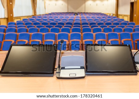 Rostrum With Microphone And Computer In Conference Hall