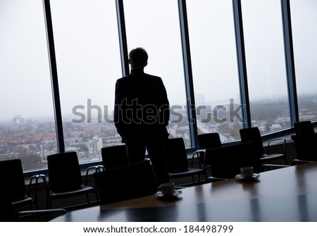 Side view of a businessman looking through window