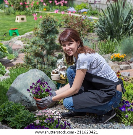 Happy female working in garden in summer