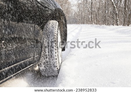 car driving in forest with much snow