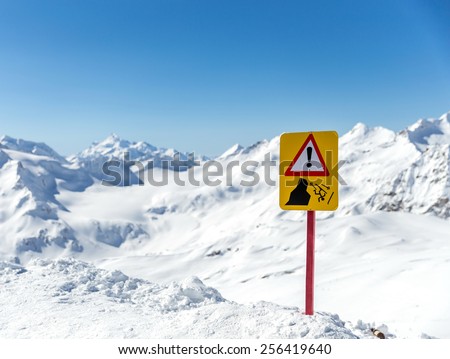 Warning sign in  beautiful mountain landscape. Sign warns about the risk of falling