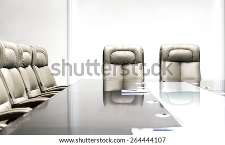 conference room with wooden table and beige leather armchairs