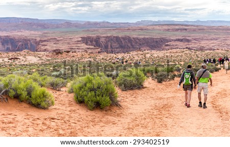 PAGE, ARIZONA - MAY 25: Hikers at Horseshoe Bend on May 25, 2015 in Page AZ,USA. Thousands of people from all over the world  visit this unique place every year.
