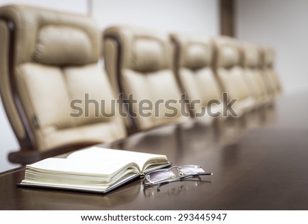 Closeup of  on table in empty corporate conference room before business meeting in office