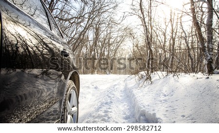 Driving SUV car in winter on forest road with much snow