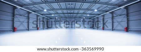 Panorama of empty room of modern storehouse with gates
