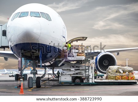 Loading cargo on plane in airport before flight