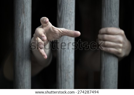 prisoner behind wooden bars