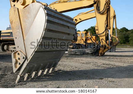 Lineup of Construction Vehicles At Construction Site, Backhoe upfront