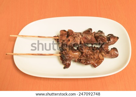 grilled chicken liver two sets on the white dish