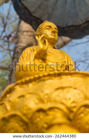 the ancient gold buddha statue under the sun light