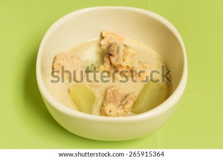 chicken in coconut milk soup on the green tablecloth