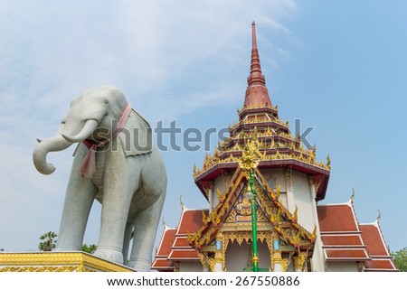 elephant stone carving under the sunlight with worship background