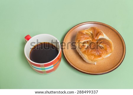 pineapple bread  on the brown dish with black coffee
