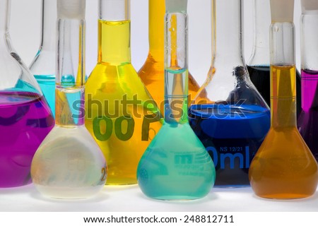 indicator solutions in flasks on lab desk