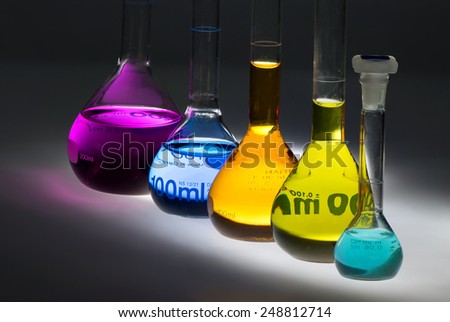 colored chemical flasks in mystical light