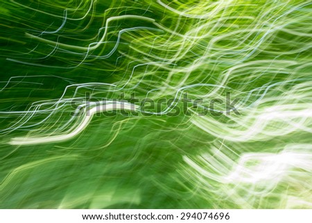 light lines through a garden hedge - real camera shot by panning technique