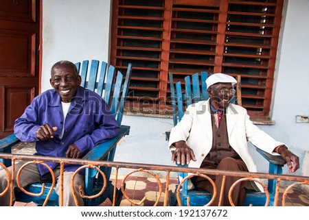 HAVANA, CUBA - FEBRUARY 15: Happy elderly cuban men sits in chairs in veranda in city Havana, Cuba on February 15, 2011
