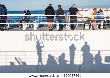 ORKNEY ISLAND, UK - JULY 05: Tourists watch the land pass by as they sail on a passenger ferry towards the Orkney Islands in Scotland on July 05, 2009