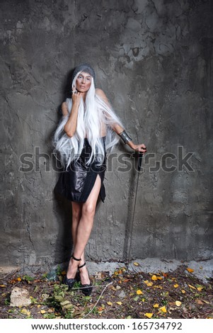 Girl with long white hair in chain mail and sword