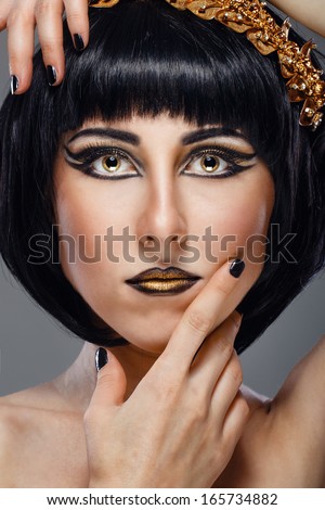 Close-up portrait of a beautiful girl with an evening make-up and jewelery