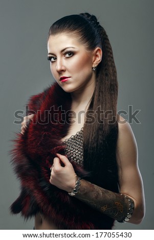 Attractive young girl with long hair in a chain-mail shirt