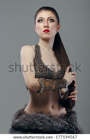 Attractive young girl with long hair in a chain-mail shirt