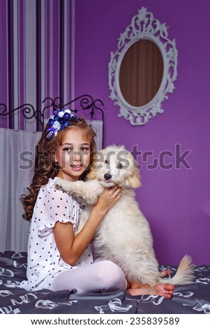 Little cute girl and dog in home interior