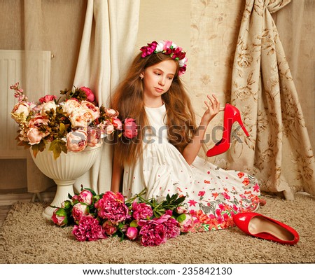 Little cute girl with doll appearance dressed in a beautiful dress. Flowers