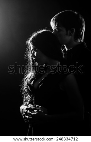 Young couple in love hugging each other, black and white photo