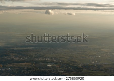 City landscape from the window the plane at an altitude of clouds crossing the line. Aerial view. Concept travel.