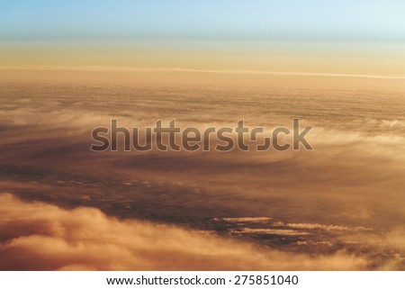 Sunset. Clouds from the altitude of the aircraft. Aerial view. Concept travel.