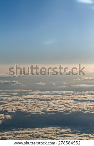 View of clouds from the window of a jet aircraft. Flying above the clouds. Clouds at dawn. Concept travel. soft focus