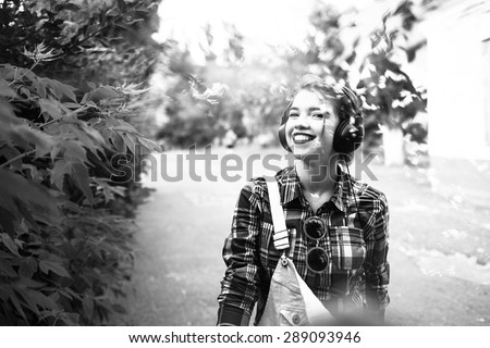 Portrait of pretty attractive girl hipster headphones. She enjoys music and smiling. Double exposure. The concept of happy life.