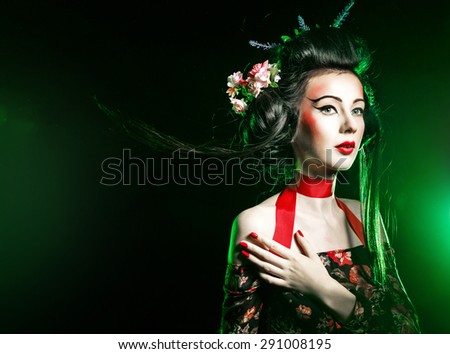 Geisha makeup and hair dressed in a kimono. The concept of traditional Japanese values.