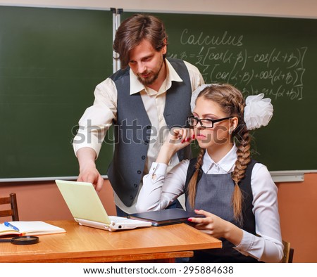 Back to school. Lesson calculus. The teacher shows an example of solving the problem on a laptop. The concept of modern education.