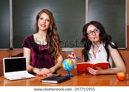 Teacher and student in geography lessons. On the table is a notebook and globe. Education concept. Back to school.