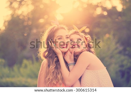 Best girlfriends embracing, close-up portrait. Girls dressed in the style of Pin-up girl. Hipster. Warm toning. Sunset. The concept of true friendship.