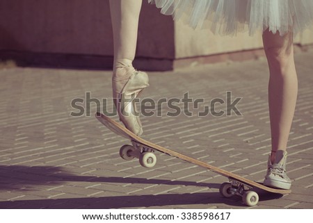 The legs of a ballerina on a skateboard. Feet shod in sneakers and ballet shoes. Modern fashion. Photo closeup.