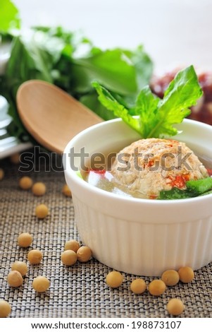 Stuffed Tofu Ball  Tofu and ground beef balls stuffed with sausage and shepherd\'s-purse leaves, which are simmered in savory soup.