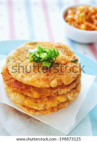 Kim chi Potato Pancakes Pan-fried potato pancakes that contain a mixture of mashed potatoes, kim chi, sweet corn kernels, cod flesh, small cubes of king oyster mushroom and chopped green onions.