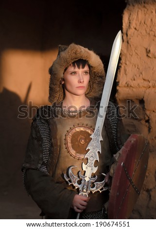 Mongolian woman warrior in ancient armor and chain mail with sword shield