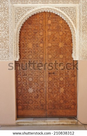 Detail form Alhambra palace in Granada, Andalusia - door made of carved wood