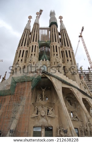 BARCELONA, SPAIN - SEPTEMBER 17, 2013: Works in progress on the facade of La Sagrada Familia - the famous church designed by Antonio Gaudi. It is anticipated that the works will be completed in 2026.